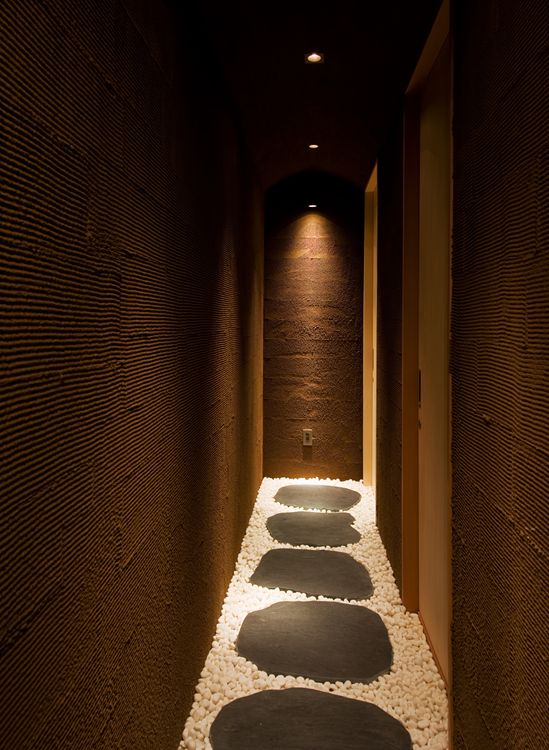 A warm palette of chocolate wood, grey walls, elm floors, and black granite (Photo: Design Hotels)