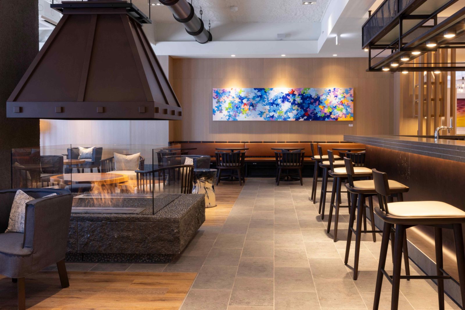 A copper still fireplace anchors the ground-level Buna Bar (Photo: Nozo Hotel)