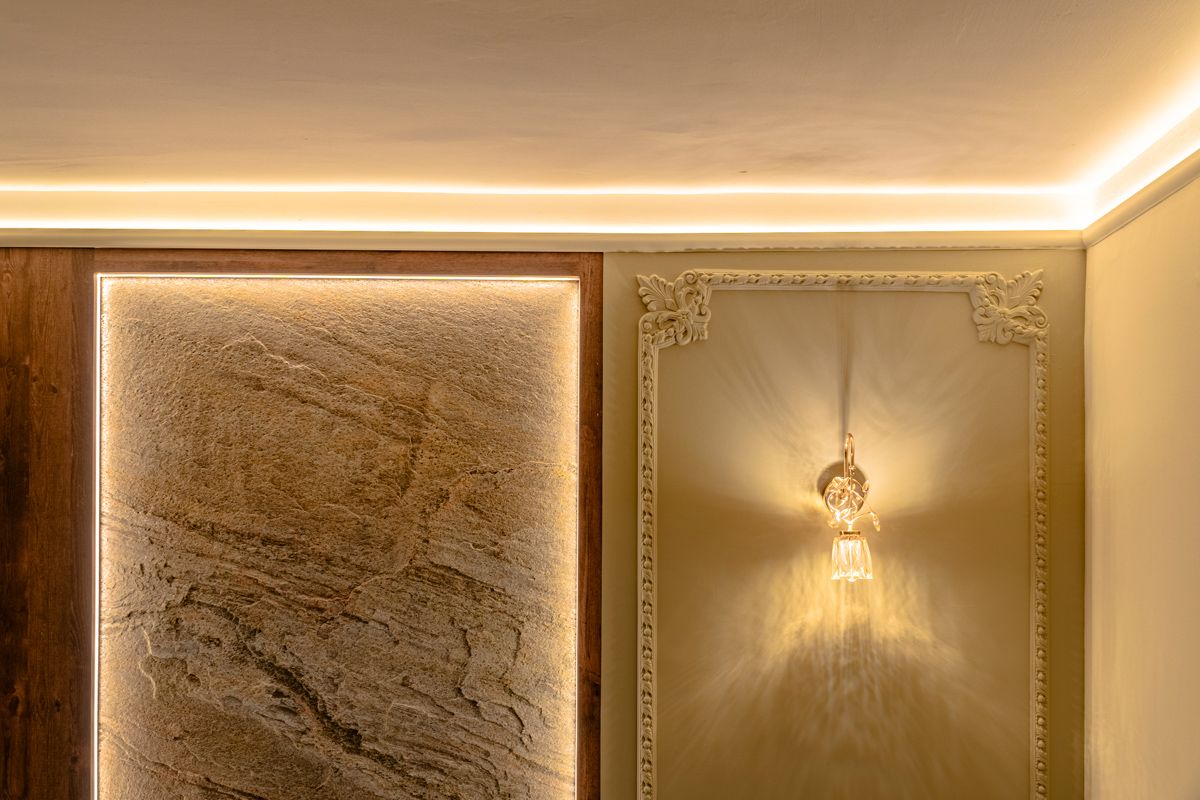 The Haga lighting strips highlights the stone and baroque wainscotting on the wall