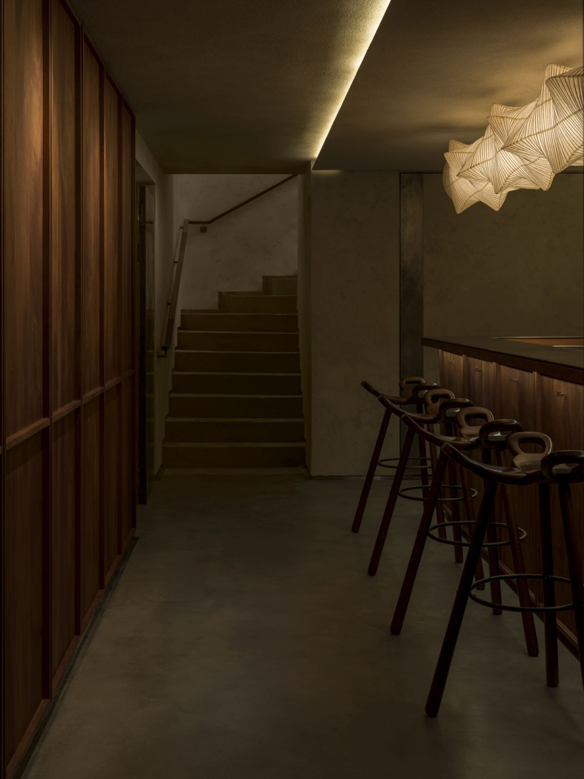 Sushi Park’s atmosphere is intimate and moody, accented by dark wood, waxed concrete, steel, and subdued lantern lighting (Photo: Saint Laurent)