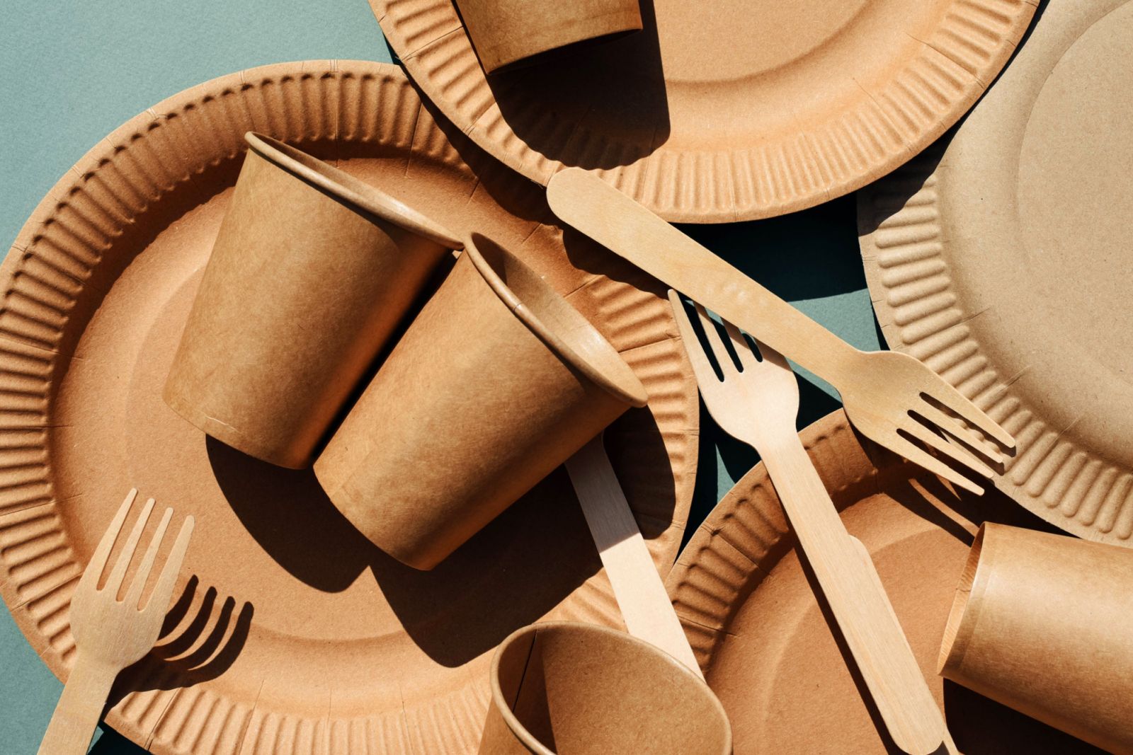 Eco-friendly craft dishes on a green background. Zero waste concept.