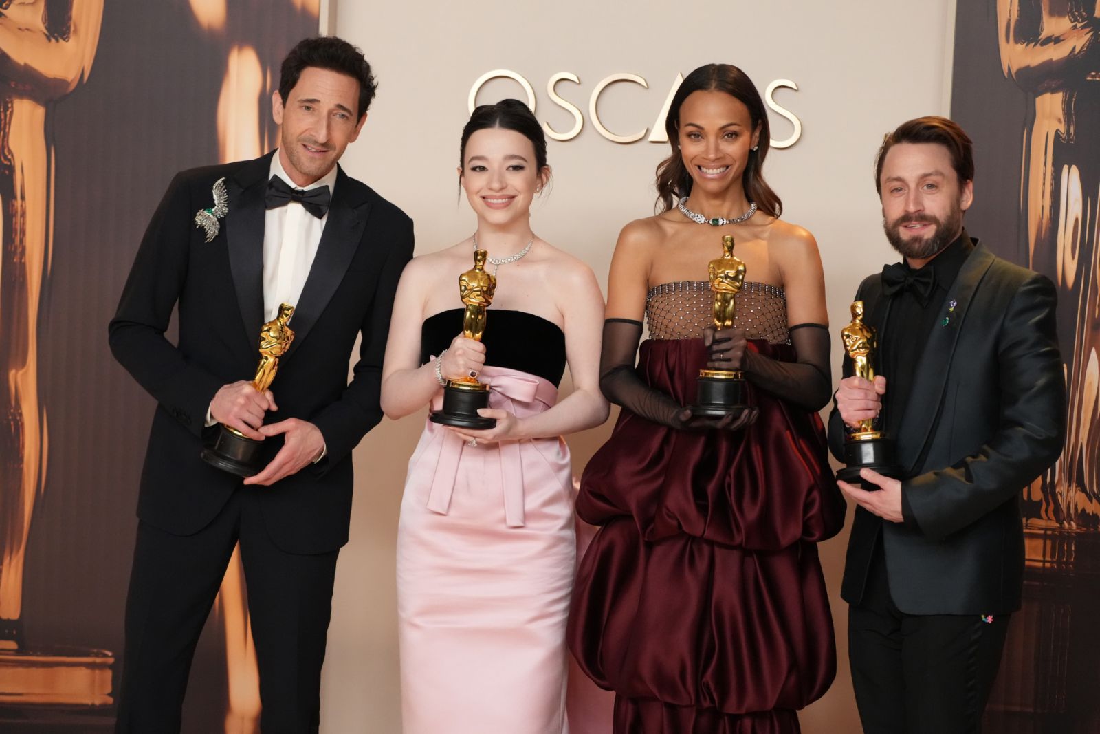 HOLLYWOOD, CALIFORNIA - MARCH 02: (L-R) Adrien Brody, winner of the Best Actor in a Leading Role for “The Brutalist”, Mikey Madison, winner of the Best Actress in a Leading Role for “Anora”, Zoe Saldaña, winner of the Best Actress in a Supporting Role for “Emilia Pérez”, and Kieran Culkin, winner of the Best Actor in a Supporting Role for “A Real Pain”, pose in the press room during the 97th Annual Oscars at Dolby Theatre on March 02, 2025 in Hollywood, California. (Photo by Jeff Kravitz/FilmMagic)