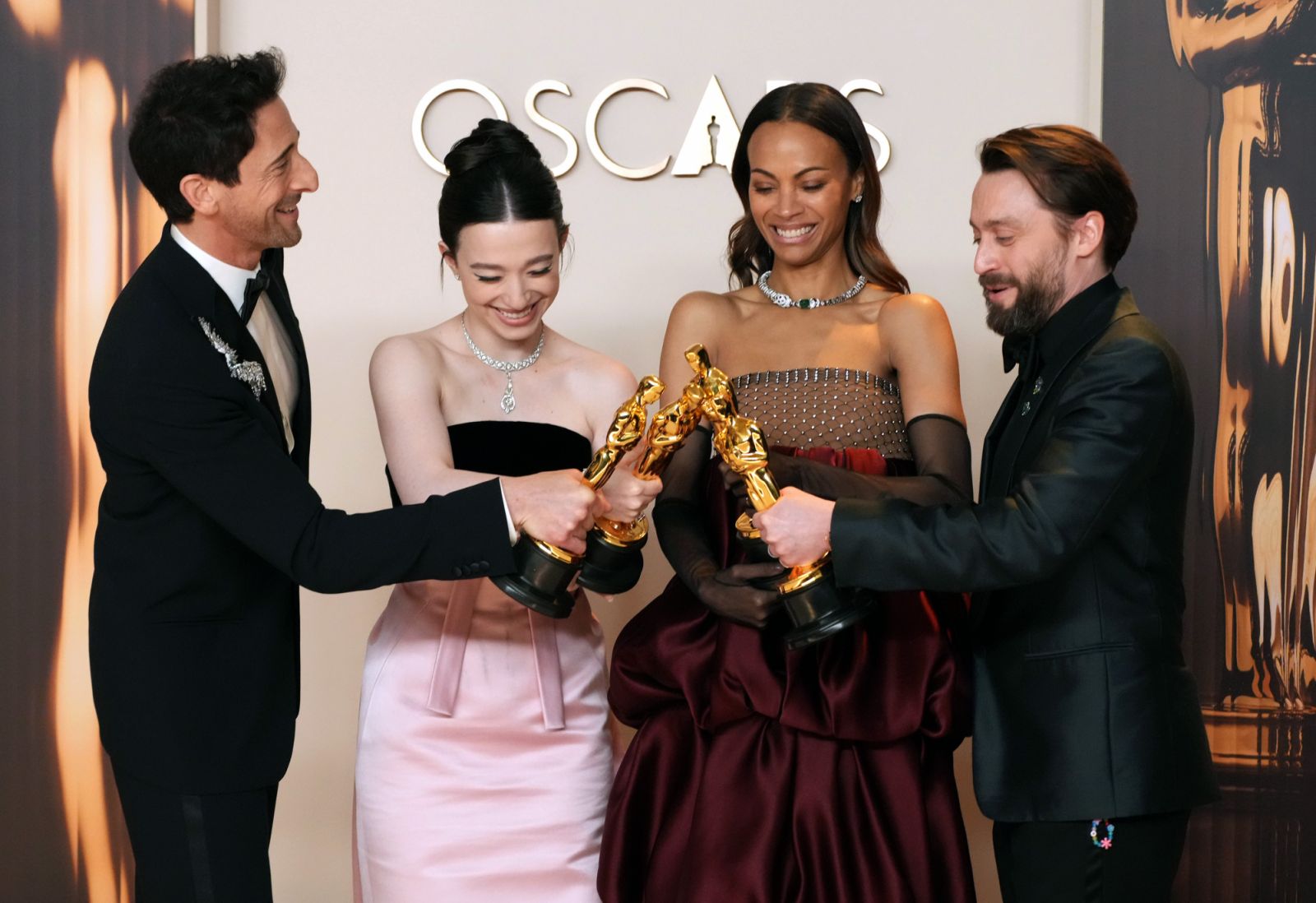 HOLLYWOOD, CALIFORNIA - MARCH 02: (L-R) Adrien Brody, winner of the Best Actor in a Leading Role for “The Brutalist”, Mikey Madison, winner of the Best Actress in a Leading Role for “Anora”, Zoe Saldaña, winner of the Best Actress in a Supporting Role for “Emilia Pérez”, and Kieran Culkin, winner of the Best Actor in a Supporting Role for “A Real Pain”, pose in the press room during the 97th Annual Oscars at Dolby Theatre on March 02, 2025 in Hollywood, California. (Photo by Jeff Kravitz/FilmMagic)