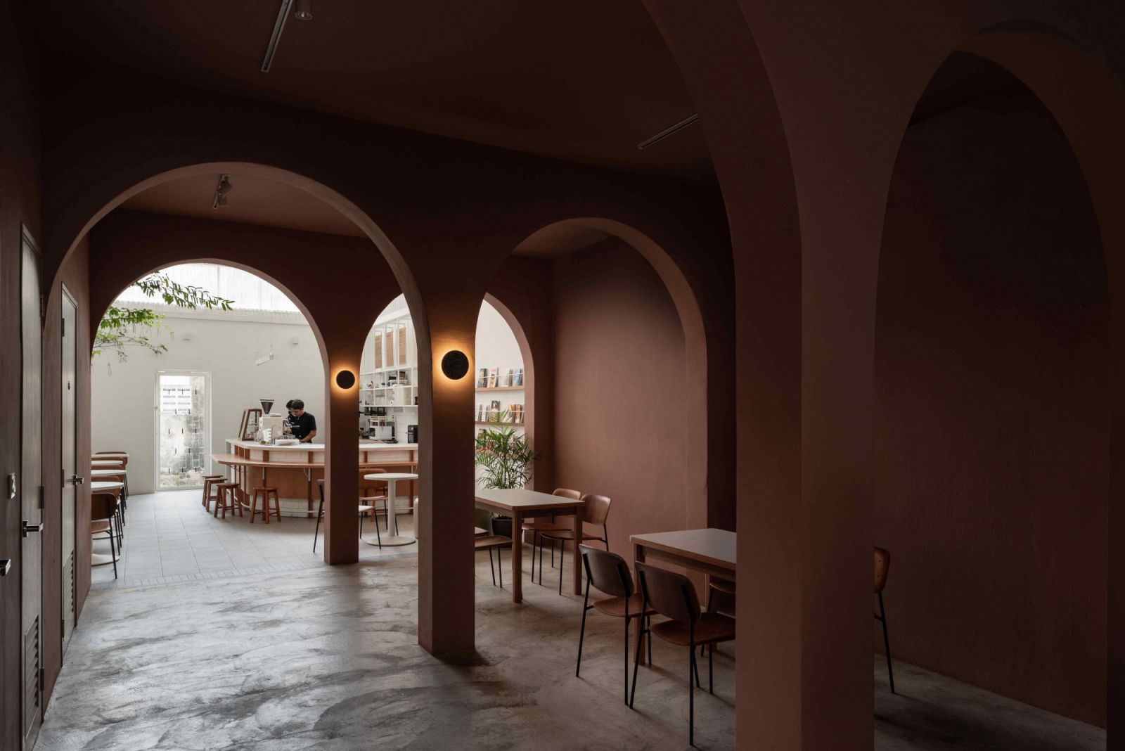 The recurring curved elements accommodate the flow of the layered spaces