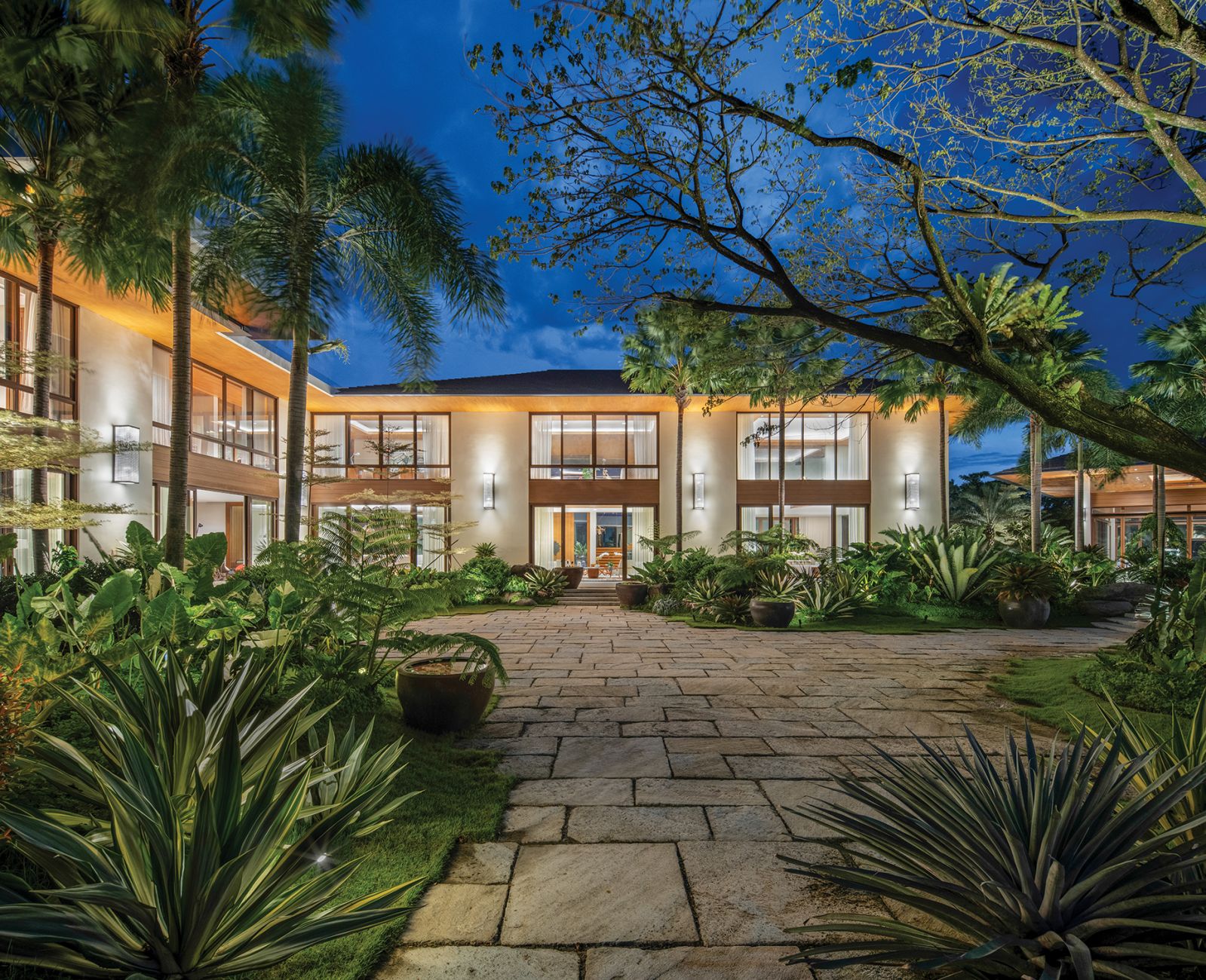 On the right foreground, part of the acacia tree around which the house was designed, and across, the first floor living rooms with high ceilings