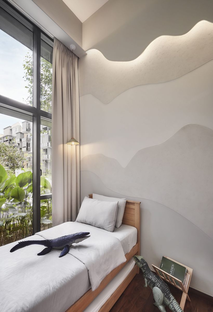 This children’s bedroom features a delicate mountainous silhouette on the wall, encouraging a sense of adventure