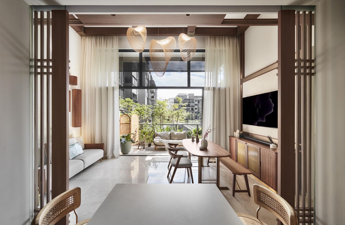 Sheer full-height curtains and organic-shaped pendant lamps lend a serene, resort-like vibe to this space; t
