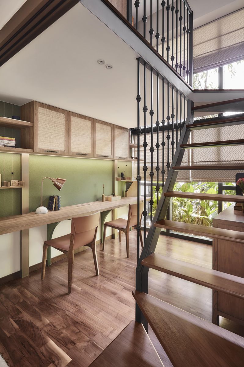 The study area beneath the staircase showcases subtle textures and a fresh colour palette