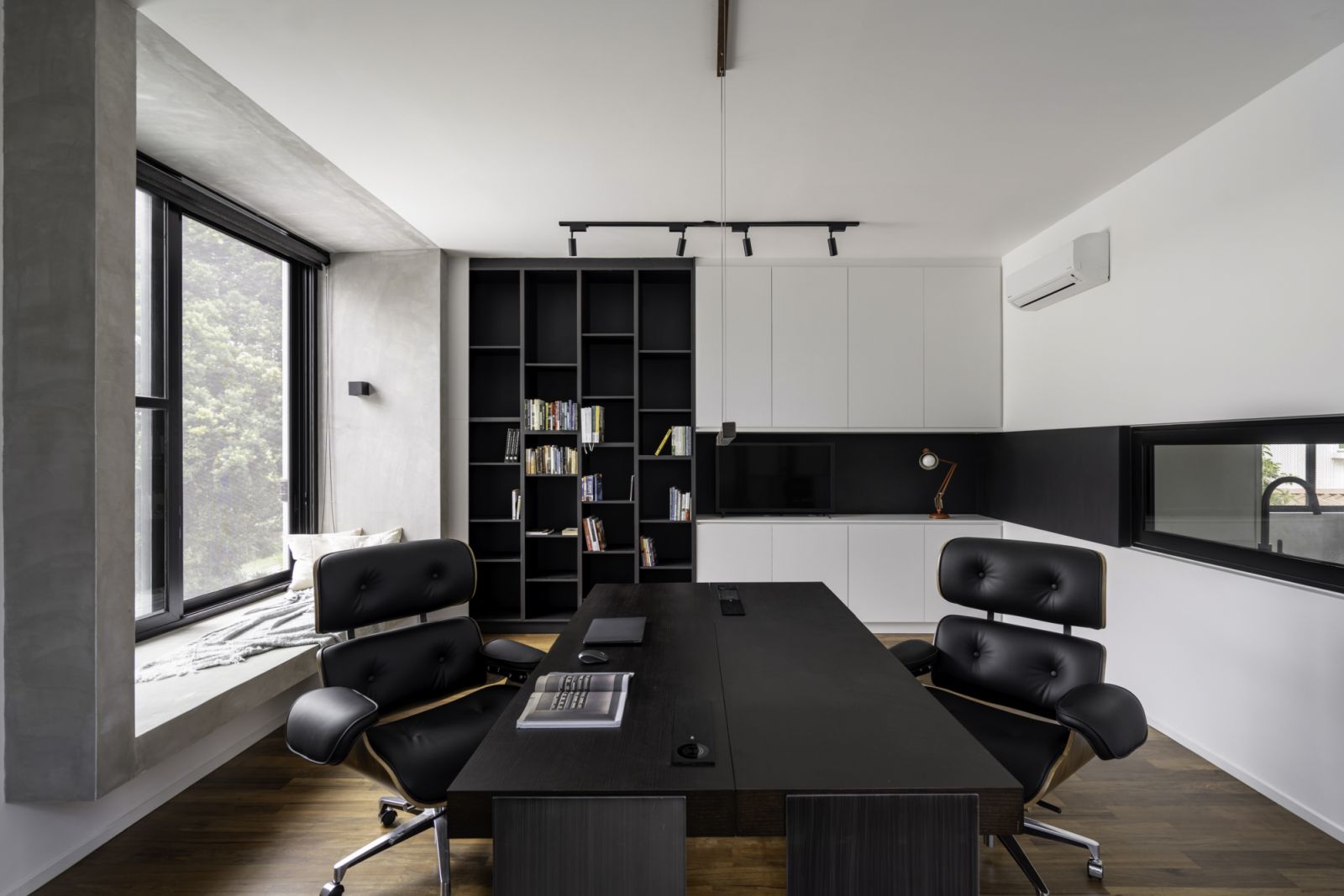 The home office reveals a sophisticated monochromatic palette with a balance of black and white elements.