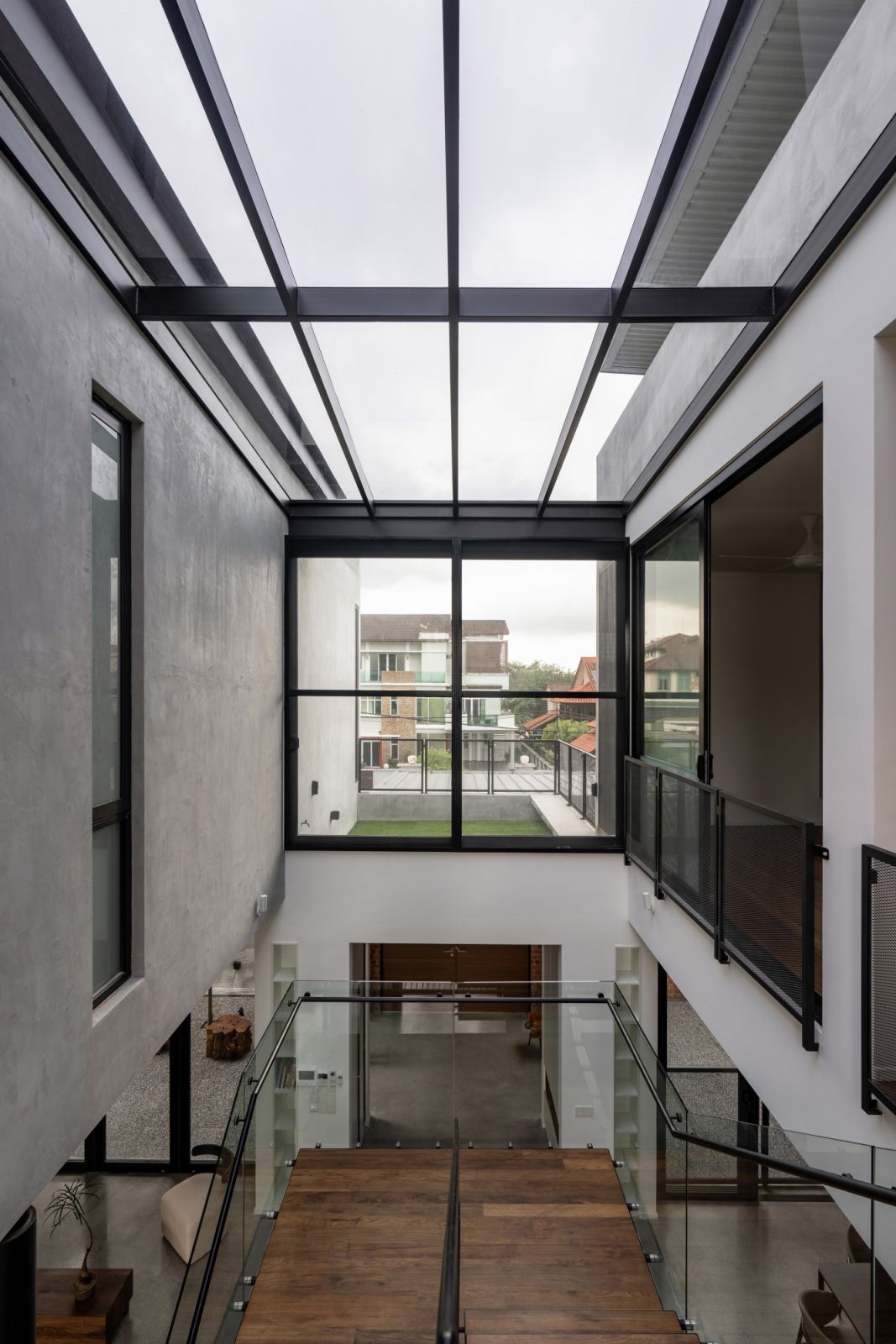 A striking architectural detail featuring a towering concrete wall with a narrow vertical cutout running its entire height