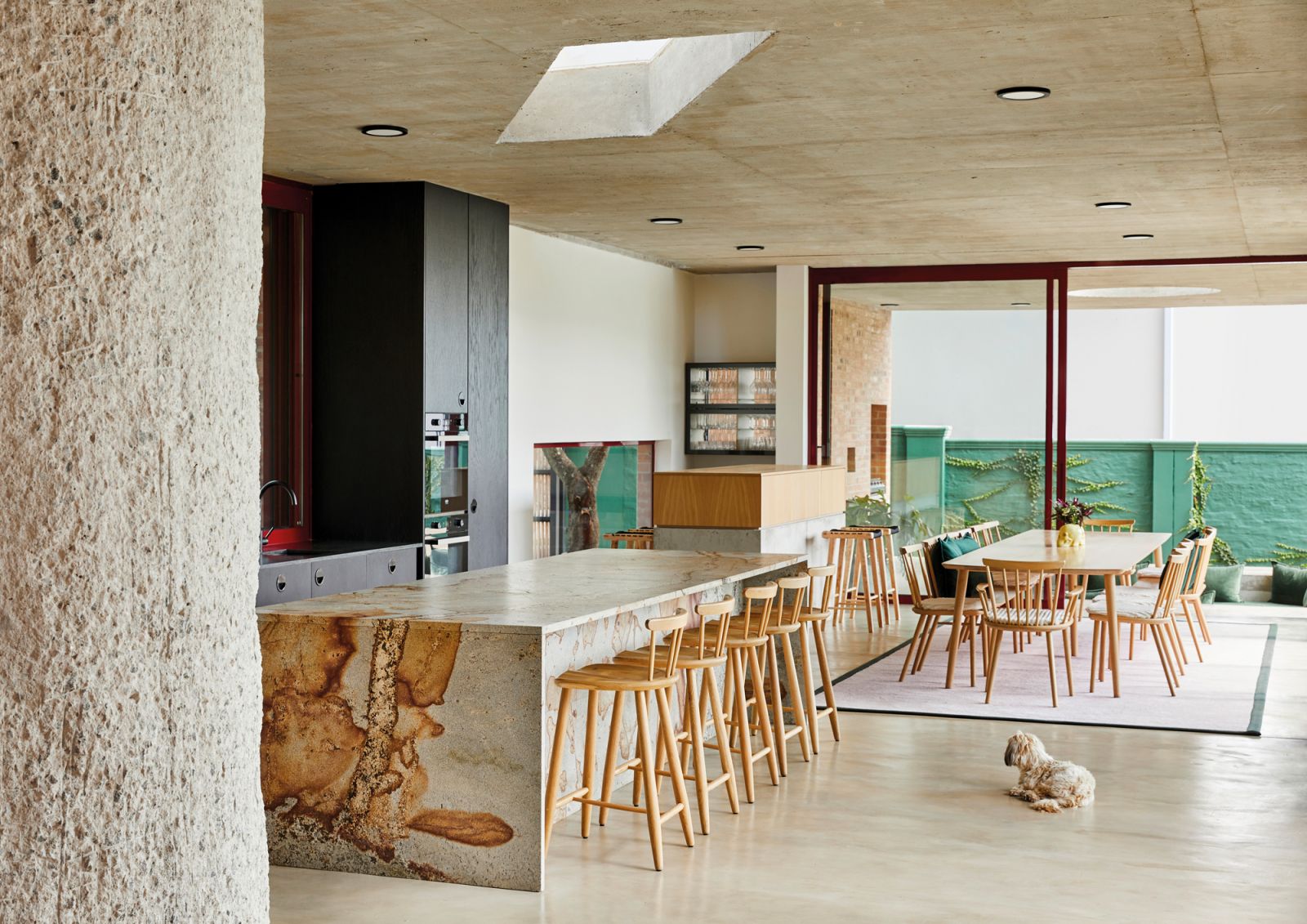 A parallelogram-shaped skylight above the kitchen island is an element of compositional dynamism and a visual pun on the shape of the block of light that a regular rectangular skylight casts