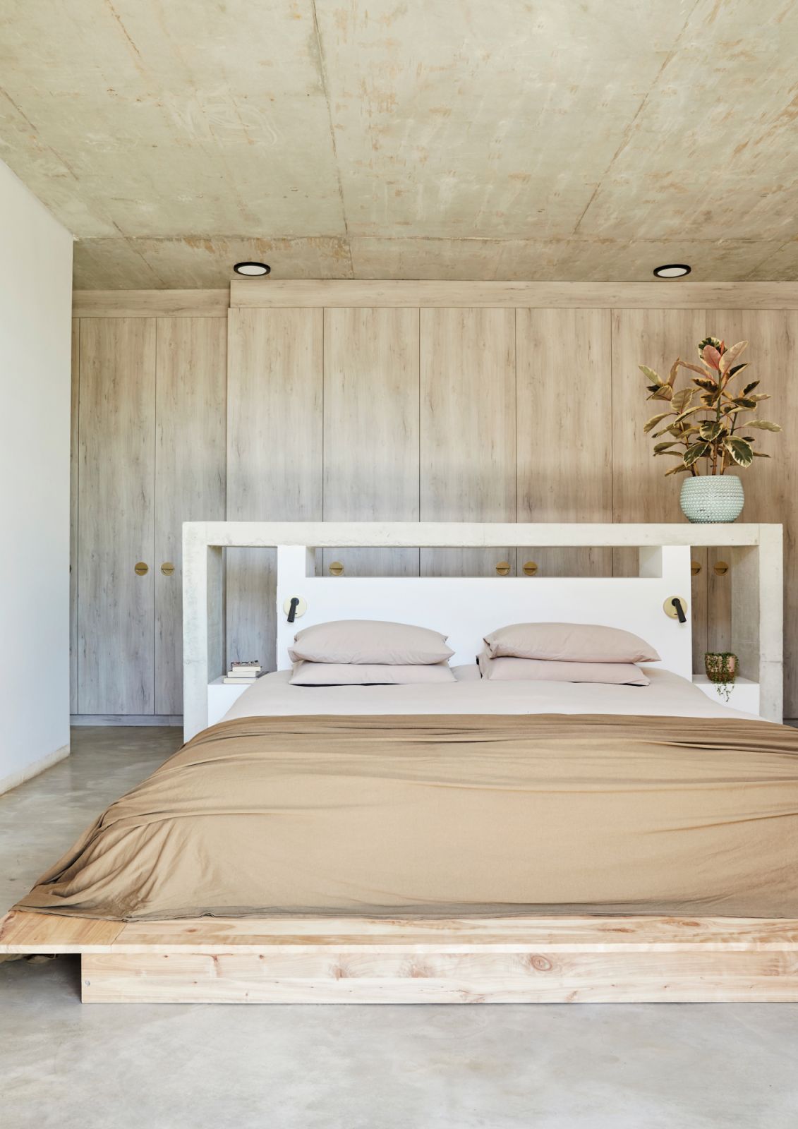The master bedroom sports a pared-back, neutral palette that conveys a serene air