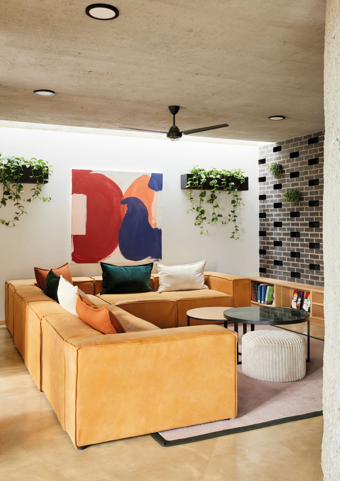 The lounge’s sofas and coffee table were custom made by Blake Matthews Interior Design and local manufacturer Up-cycled while the abstract piece is by the architect himself