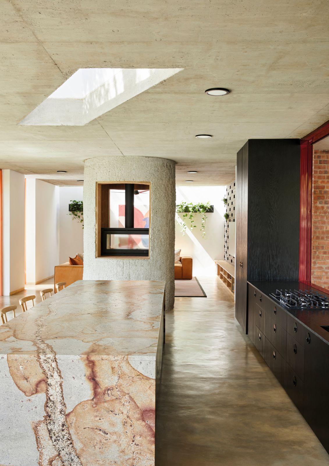 This cylindrical feature houses the fireplace and also plays a structural role in supporting the ceiling