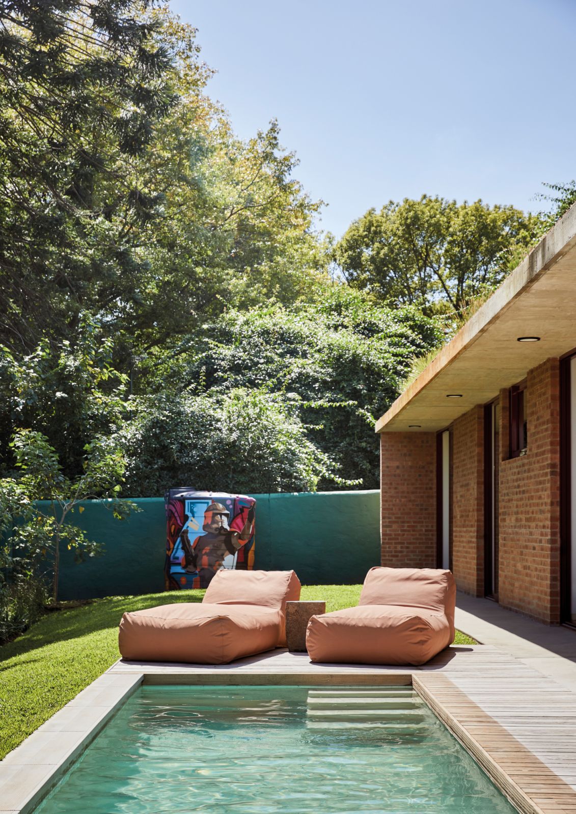 The bedrooms each open directly onto the deck and swimming-pool courtyard, imparting an almost resort-like feel