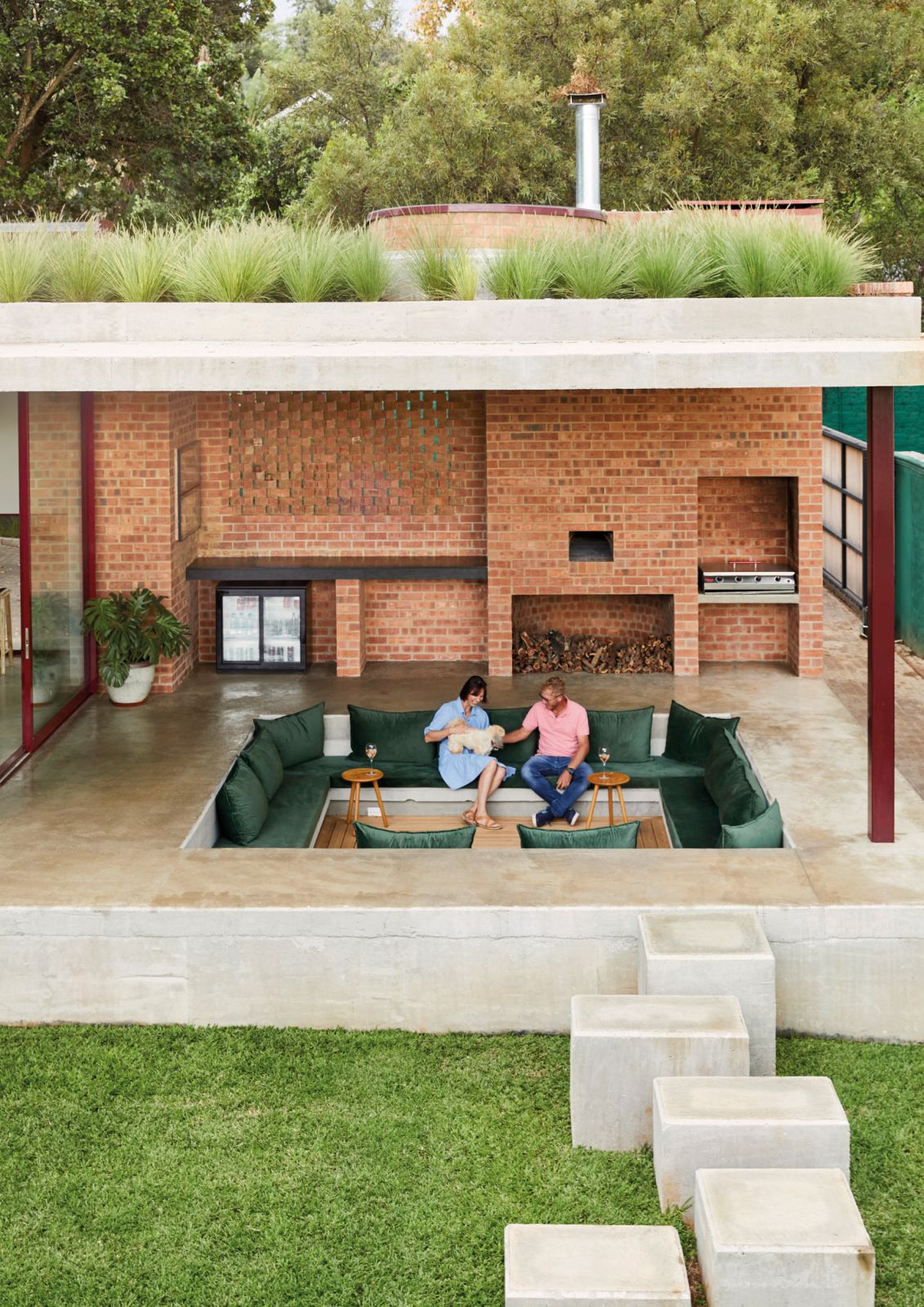 Viewed from the rooftop opposite, the sunken lounge with its barbecue and pizza oven creates a cosy nook