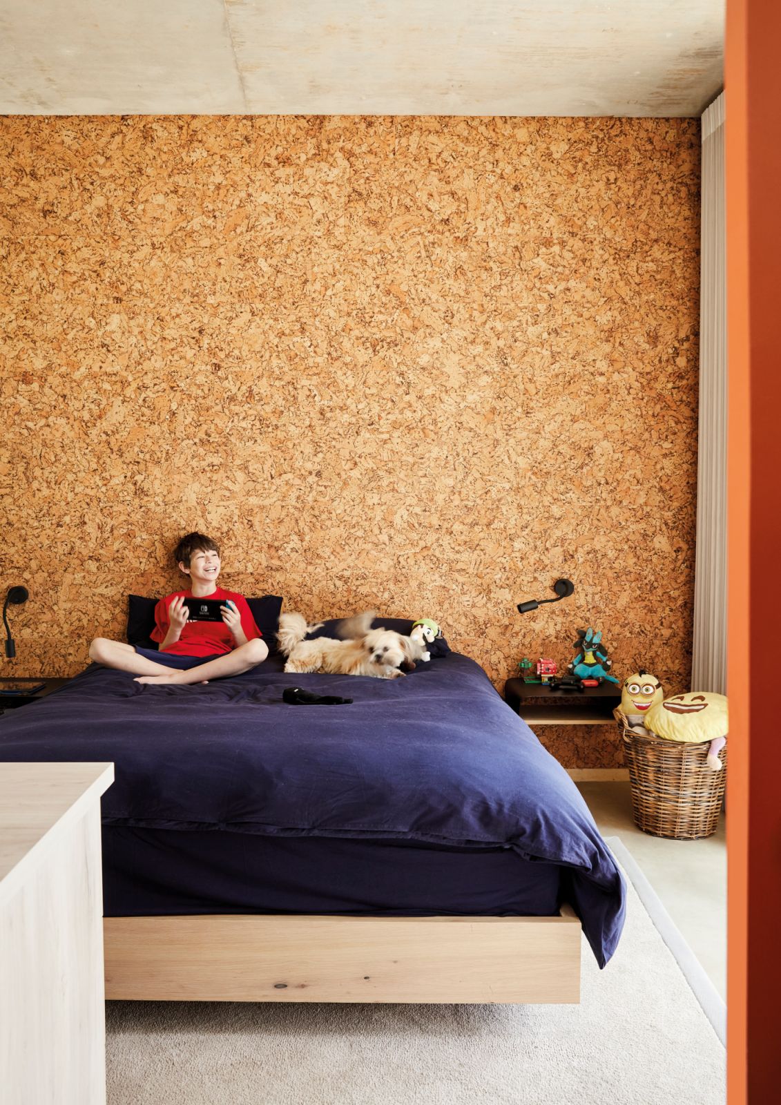 The feature wall behind son Jamie’s bed is clad in cork, adding tactility and a sense of warmth