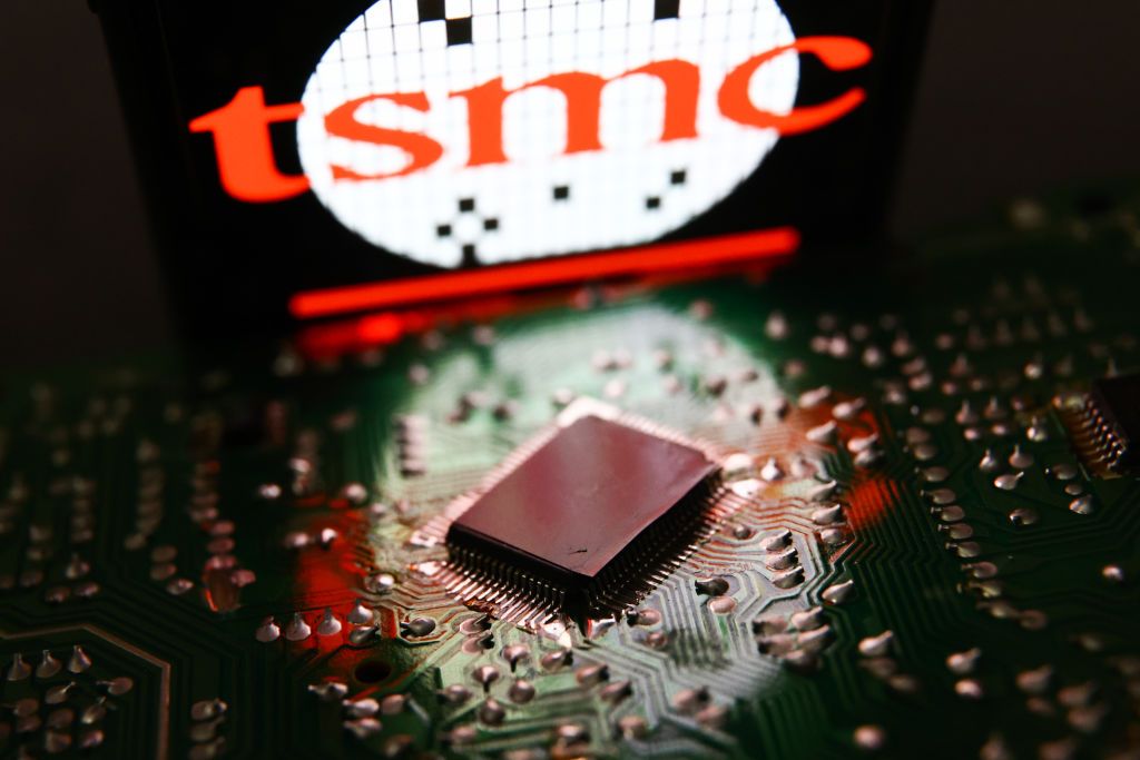 TSMC displayed on a phone screen and microchip and are seen in this illustration photo taken in Krakow, Poland on July 19, 2023. (Photo by Jakub Porzycki/NurPhoto via Getty Images)