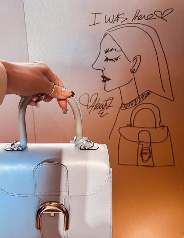 Heart Evangelista sketches a quick drawing at Delvaux (Photo: Instagram/@iamhearte)