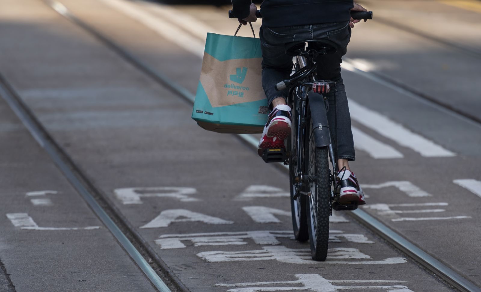 HONG KONG - DECEMBER 30: A customers carries a purchase food order from delivery take out food company Deliveroo in Hong Kong on December 30, 2021. (Photo by Miguel Candela/Anadolu Agency via Getty Images)