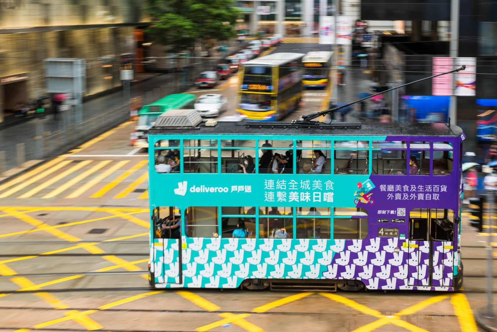 A Hong Kong tramway decorated with a publicity for the food delivery company Deliveroo passes in Central Hong Kong in a panned shot, on May 15, 2022. (Photo by Marc Fernandes/NurPhoto)