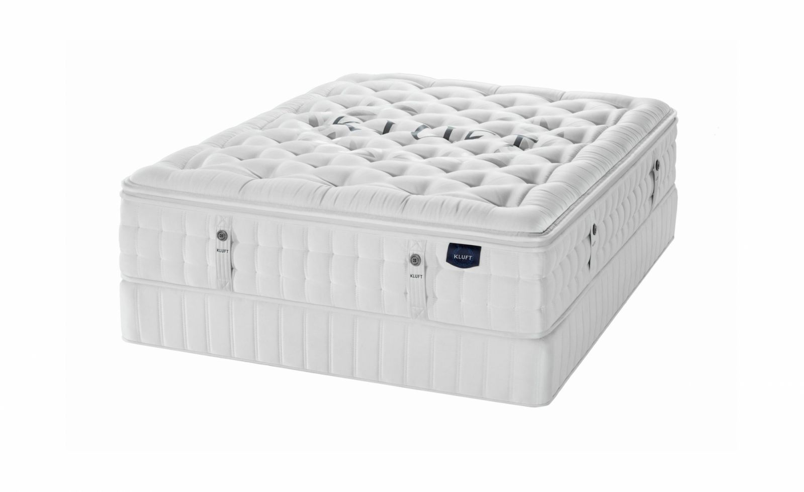 The Kluft Signature Series mattress showcases exceptional American craftsmanship with its pristine white finish and meticulous hand-tufting.