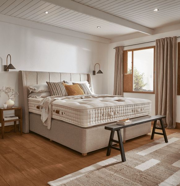 A Hypnos mattress features hand-tufting across its surface with visible row stitching along the border set against the brand’s signature medium-profile design (Photo: Hypnos)