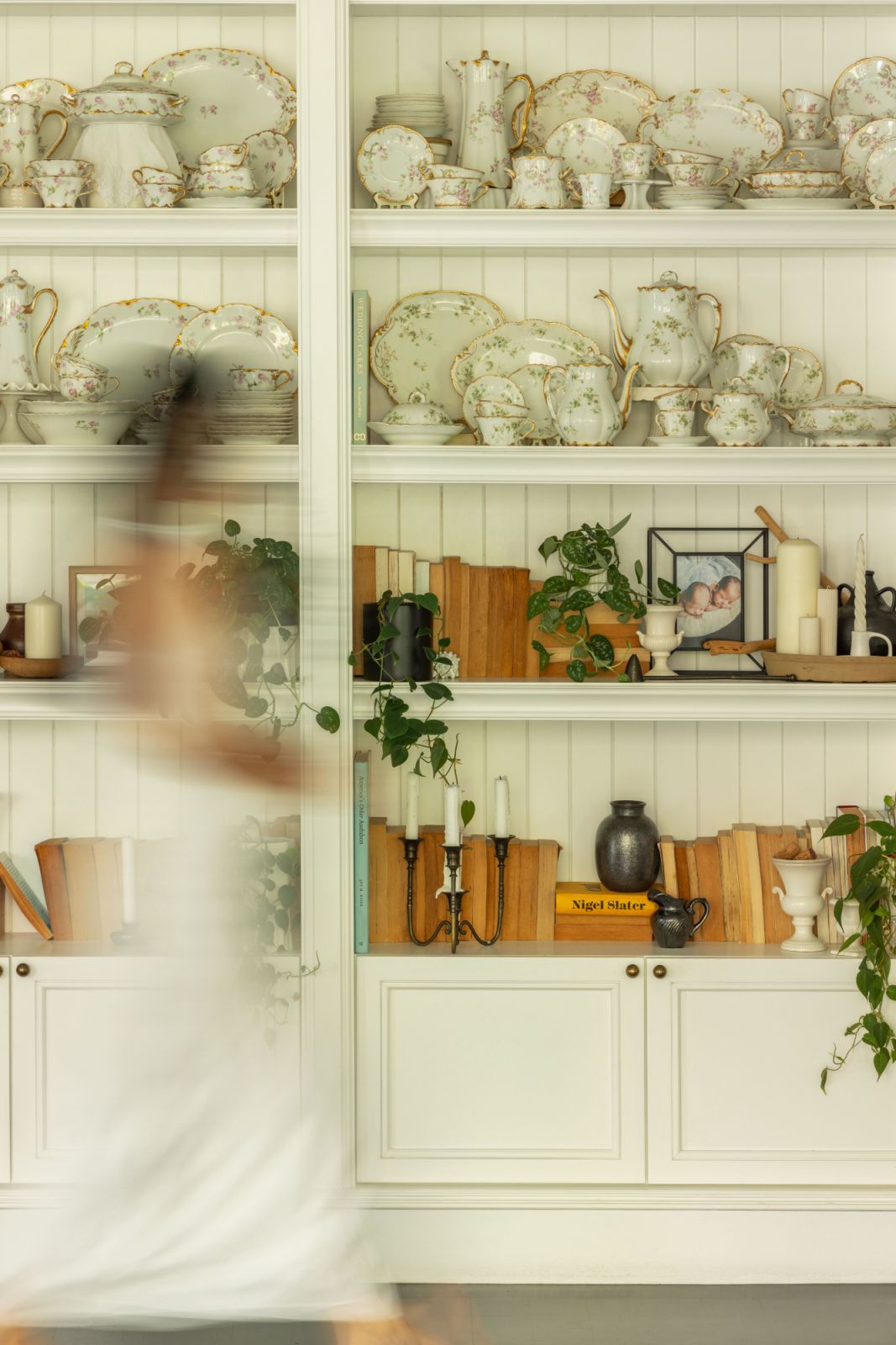 A floor-to-ceiling display unit houses Lai’s carefully curated collection of antique teacups and vintage pottery