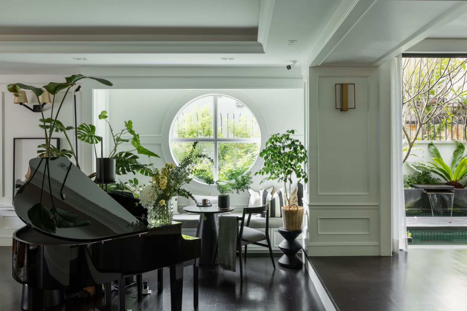 This neoclassical residence features striking contrasts of white wood panelling and black flooring throughout