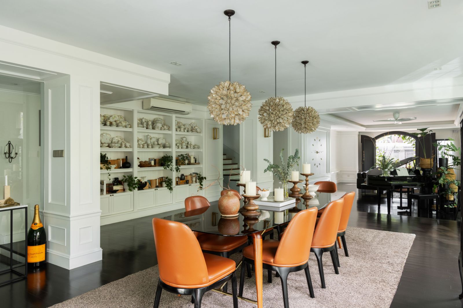 The dining space balances neoclassical elements with contemporary functionality