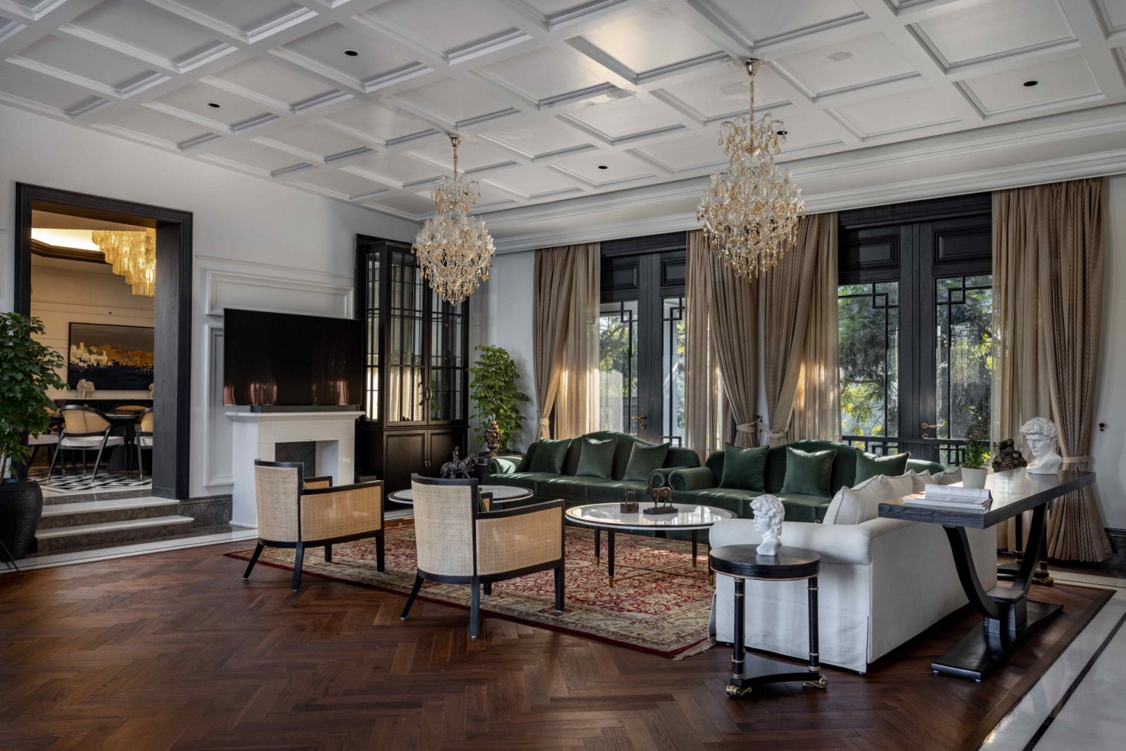The secondary living area with ornate cornices and chandeliers