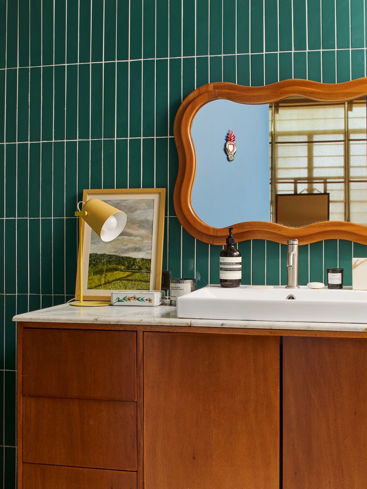 The renovated master bathroom in the Marikina home, with subway tiles and mahogany furniture