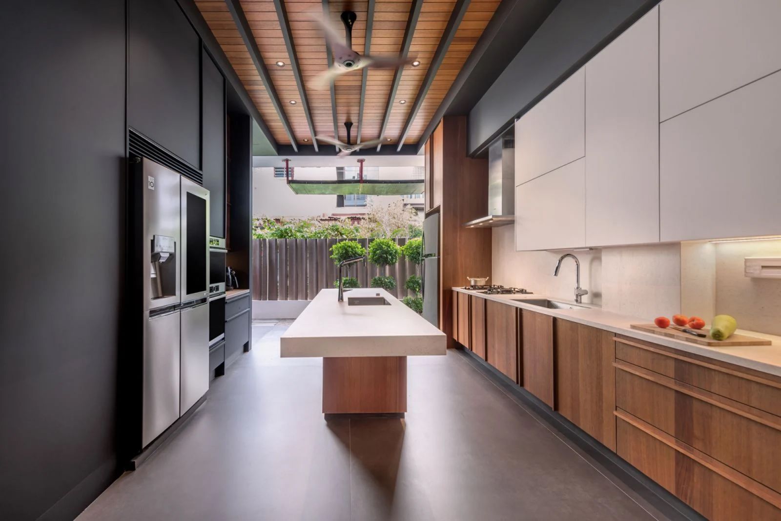 A warm, wood-clad kitchen designed by Artistroom for a tight-knit family