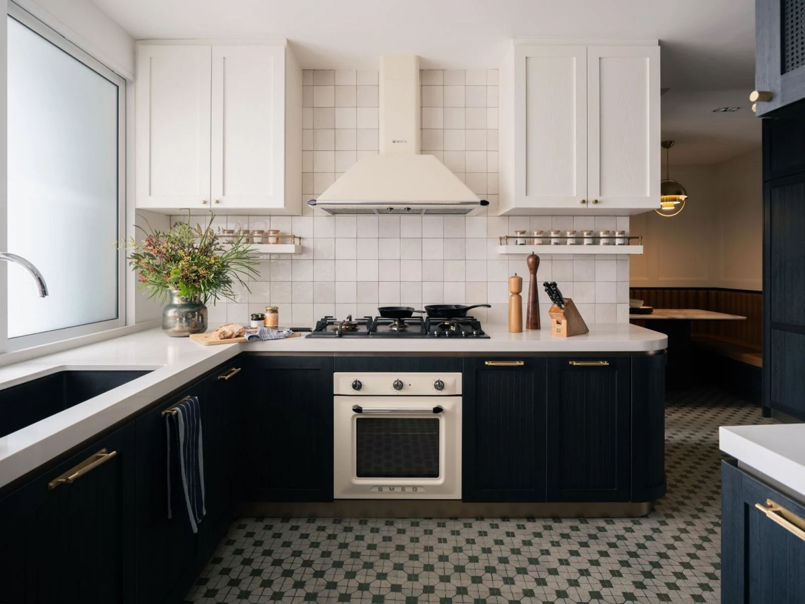 The kitchen in the Cairnhill Plaza apartment by Haus Atelier strikes a balance between demure minimalism and lush detail