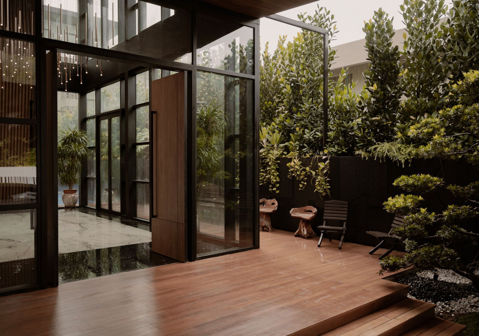 The verdant outdoors cocooning the entrance to the multigenerational Holland Grove house