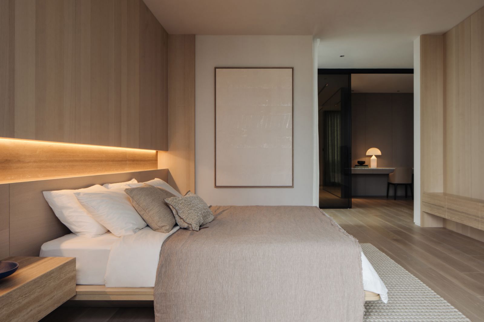 The liberal use of light wood creates a cocooning effect in the master bedroom