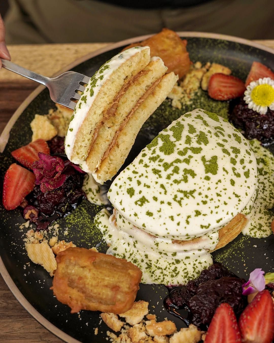 The Green Eyed Monster—fluffy Biscoff pancakes smothered in luscious green tea coconut mascarpone cream (Photo: Instagram / @yellowbrickroadcafe)