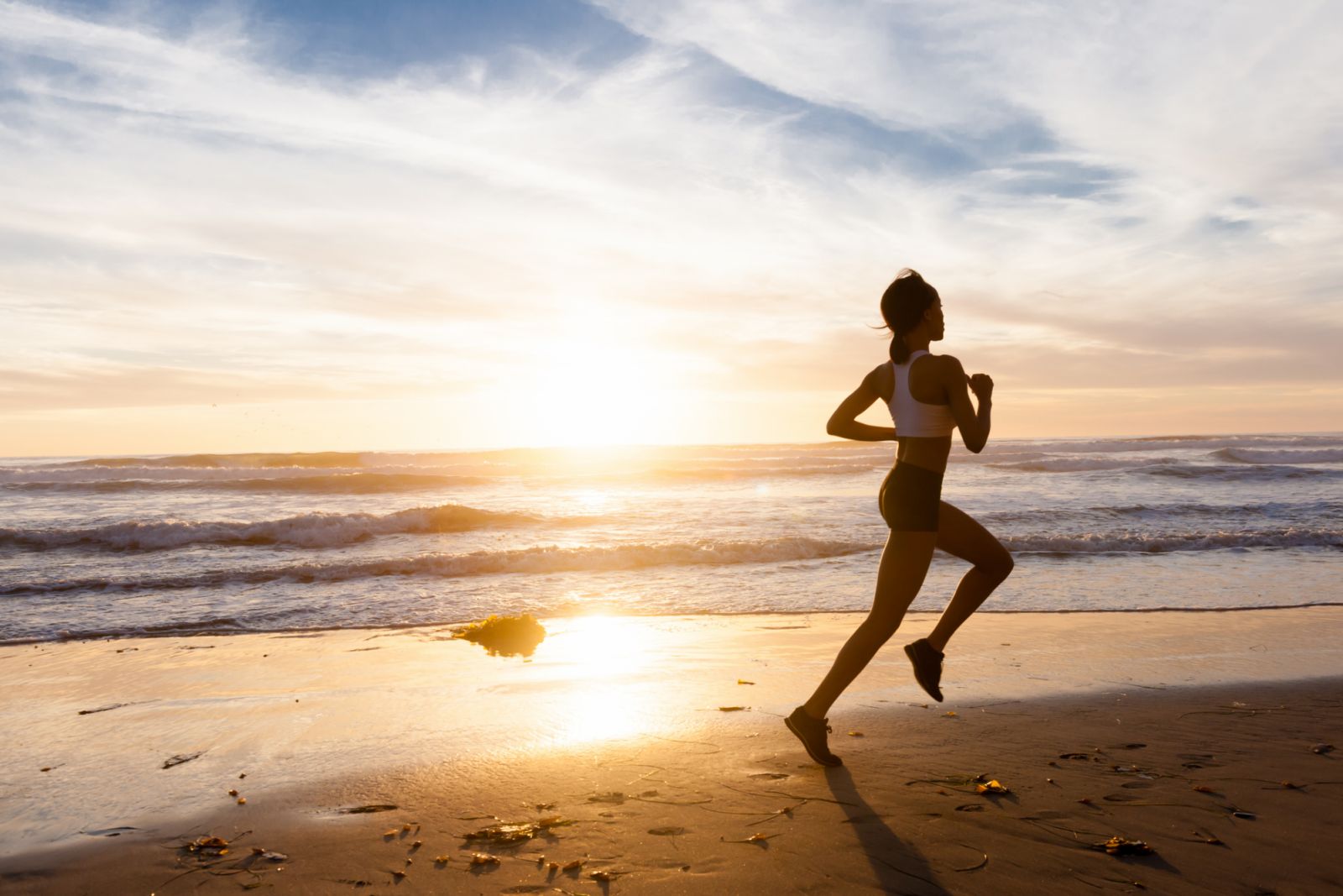 A beautiful women running at the beach during sunset.http://blog.michaelsvoboda.com/BreeRunner.JPG