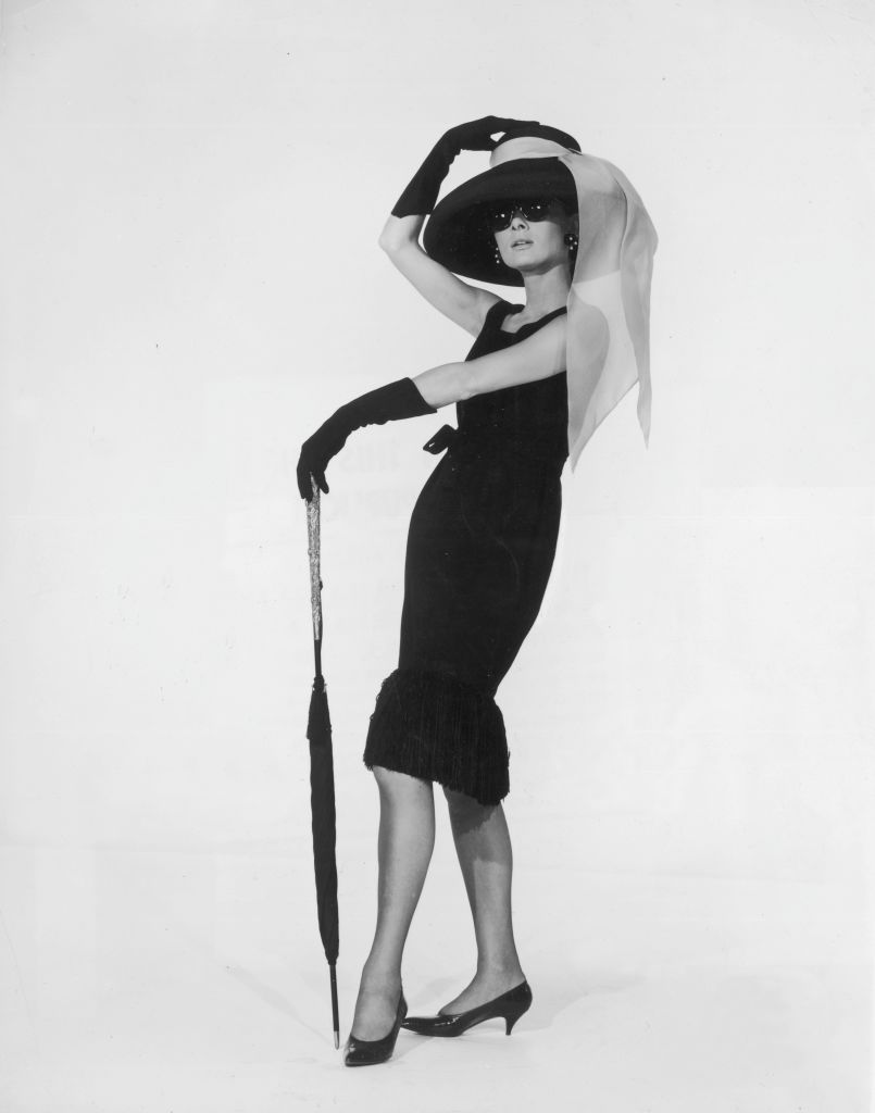 1961: Belgian-born actress Audrey Hepburn (1929 - 1993) in a black cocktail dress designed by French couturier Hubert de Givenchy in a promotional portrait for director Blake Edwards's film, 'Breakfast at Tiffany's'. (Photo by Hulton Archive/Getty Images)