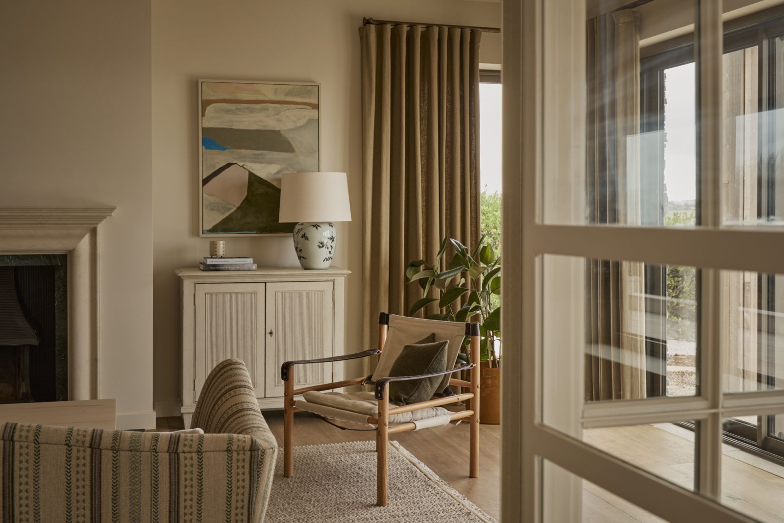 The living room with sandy sepia tones and dusty fabrics that complement the surrounding landscape