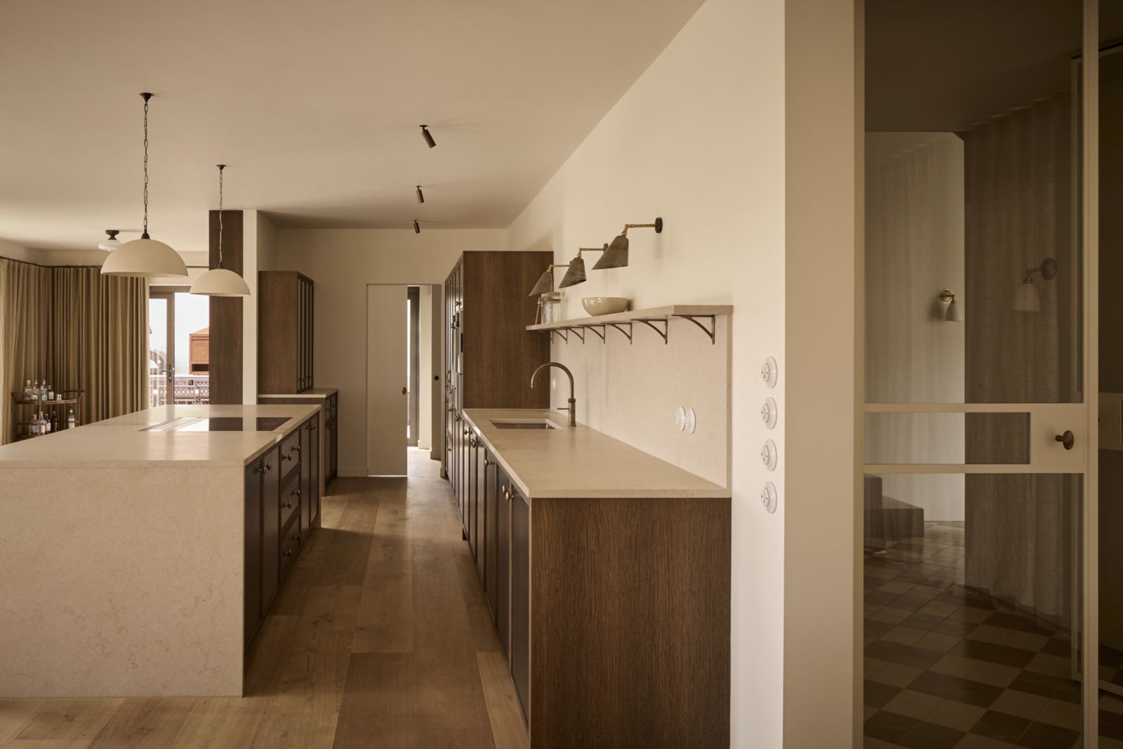 Shaker-style oak framed cabinetry with a dark stain and metal inserts adds depth and contrast