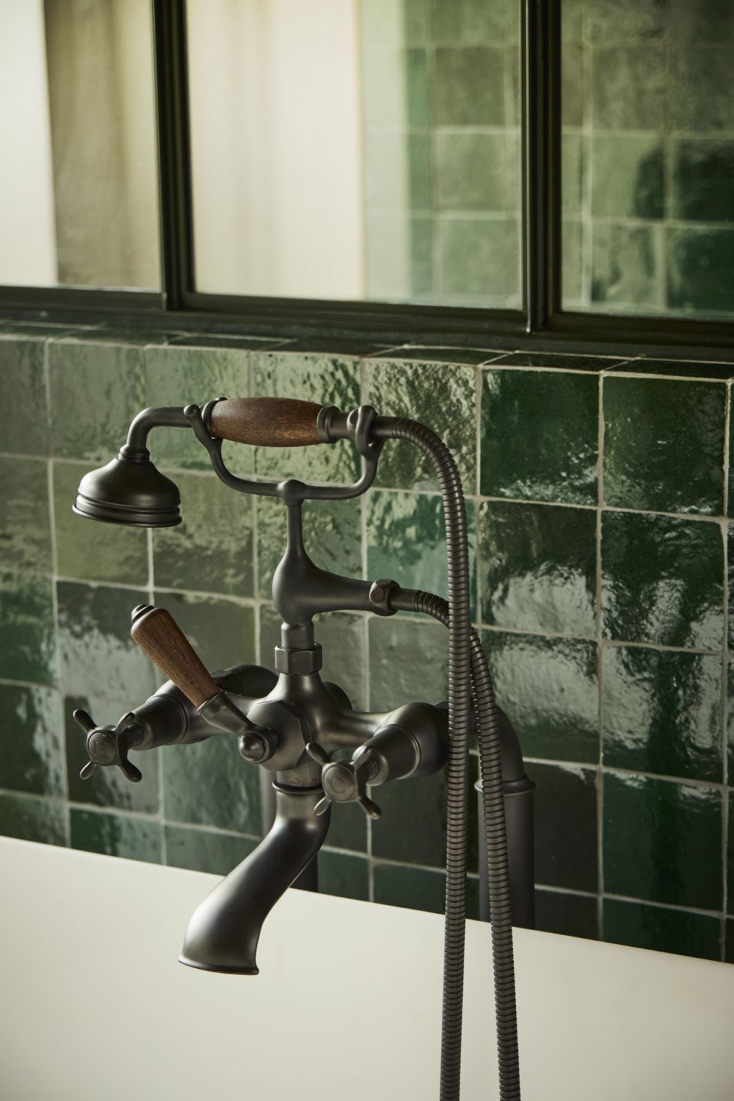 The green zellige tile wall correlates with the green marble floor