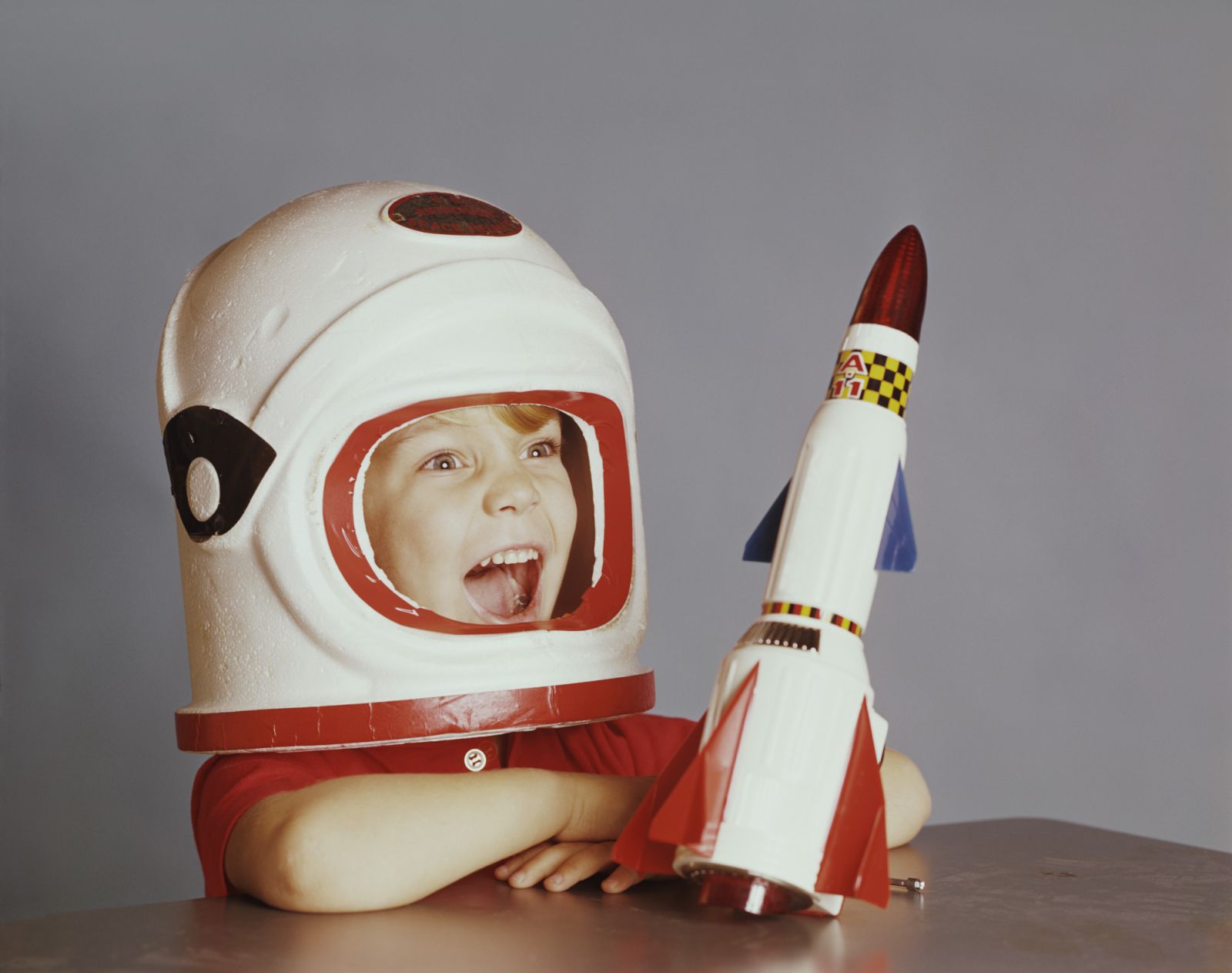 Happy Boy in Astronaut Costume with Spaceship