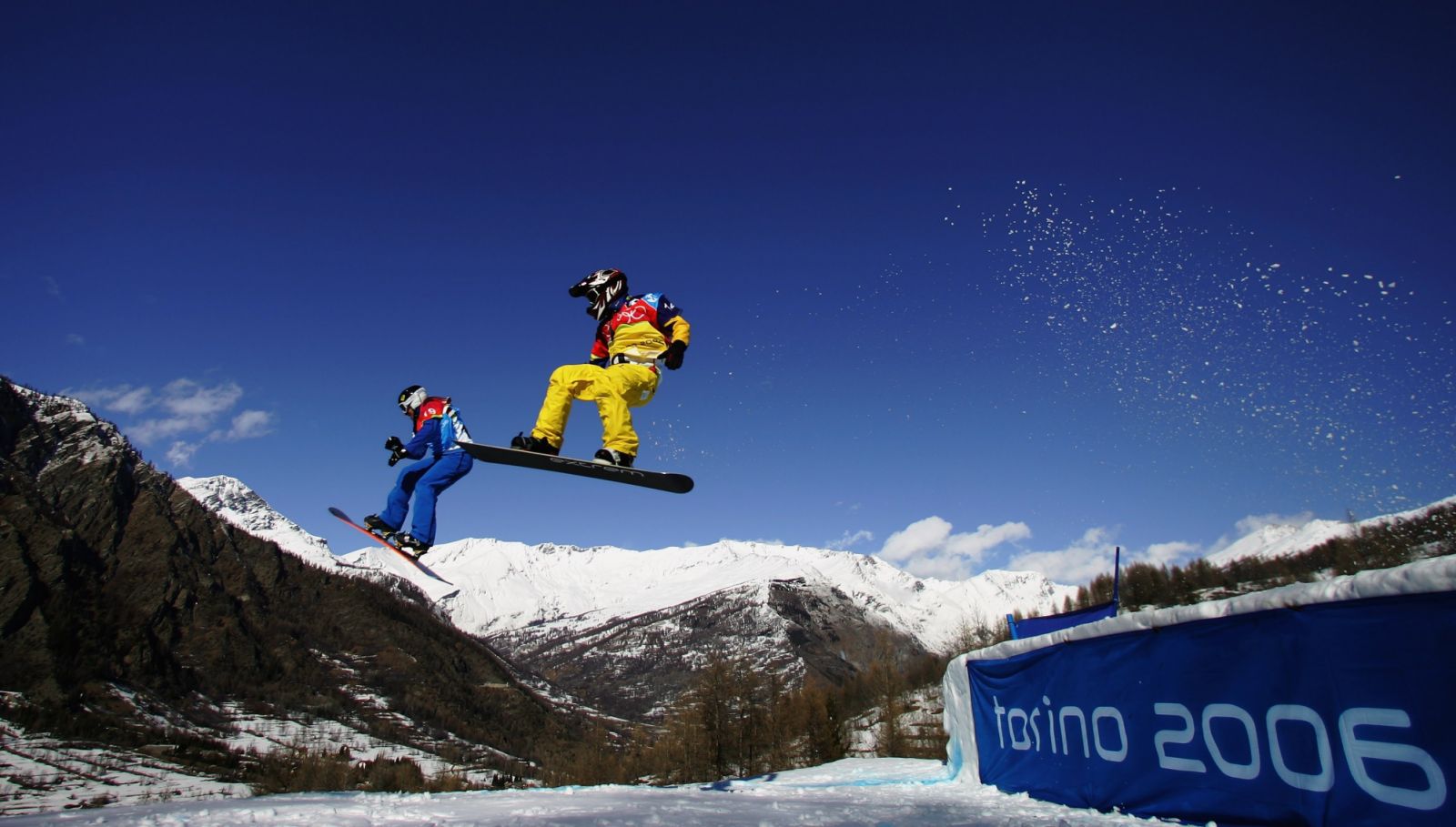 BARDONECCHIA, ITALY - FEBRUARY 16: (L-R) Stefano Pozzolini of Italy leads from Jonte Grundeliuis of Sweden during the Mens Snowboard Cross Final on Day 6 of the 2006 Turin Winter Olympic Games on February 16, 2006 in Bardonecchia, Italy. (Photo by Donald Miralle/Getty Images)