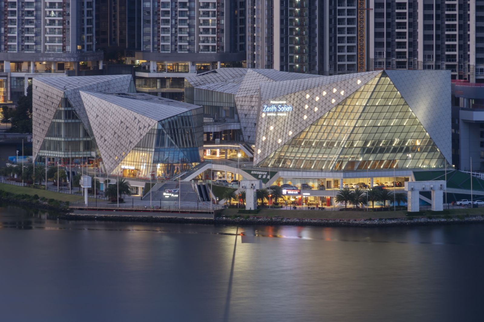 Singapore, Singapore - November 29, 2021: The Permaisuri Zarith Sofiah Opera House, located in Johor Bahru, Malaysia, is illuminated at dusk. Photograph taken across the Johor Strait in Woodlands, Singapore.