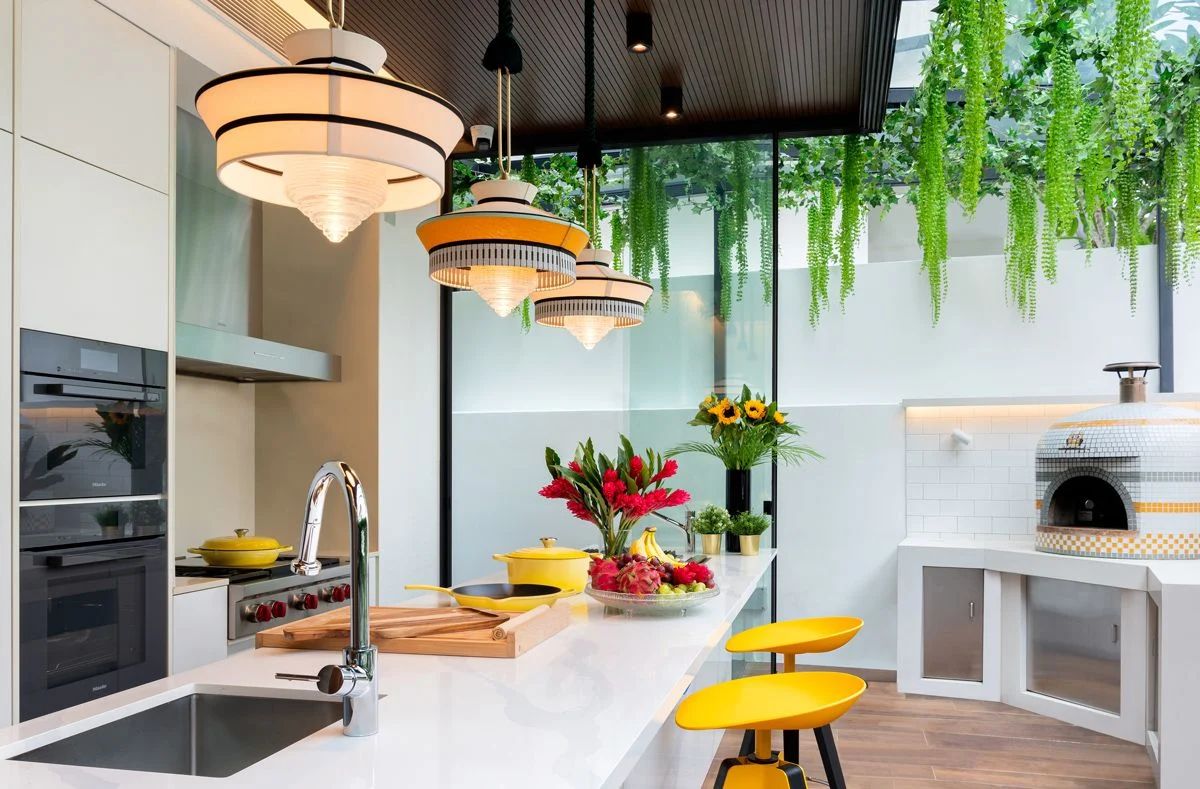 The addition of greenery overhead softens the look of the kitchen and provides shade against the harsh afternoon sun