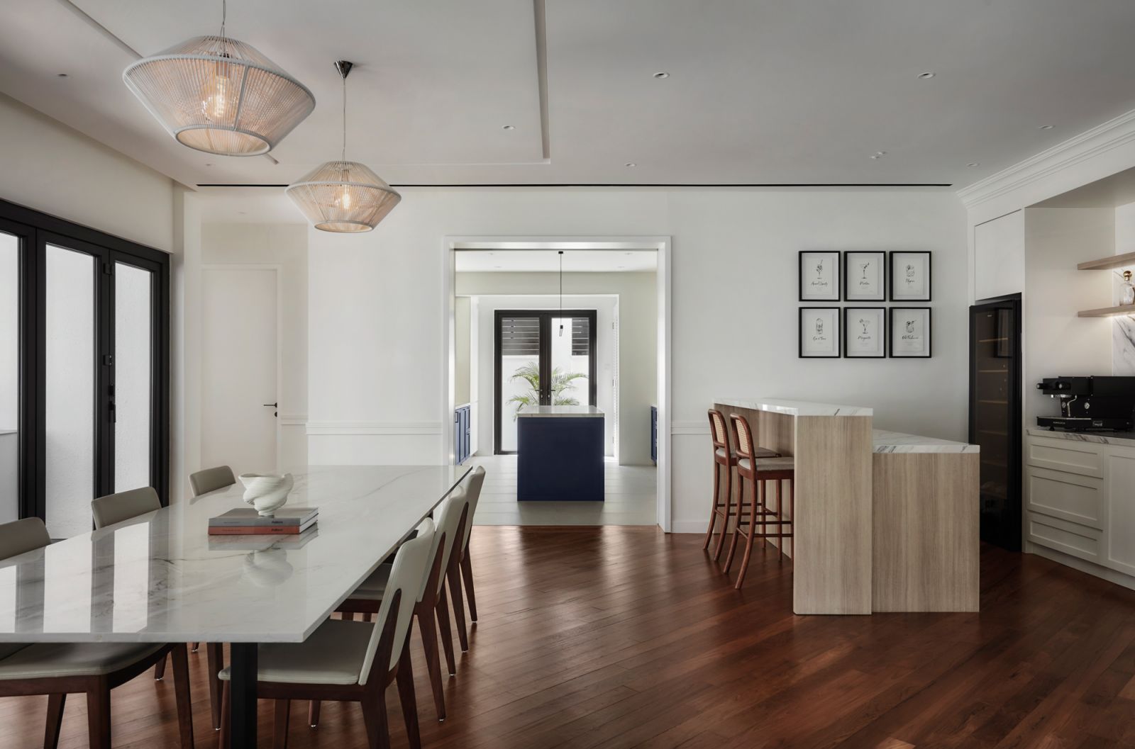 The bar-cum-dining room is furnished with a custom dining table and luxuriously finished, making it the perfect spot for entertaining
