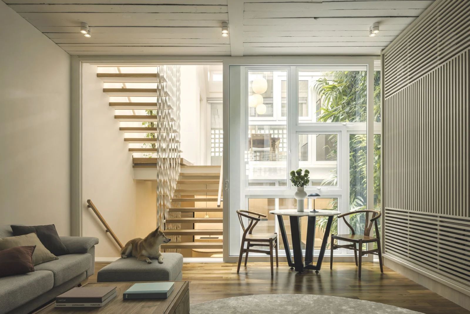 A serene sitting area with a view of the verdant green wall in this sophisticated home