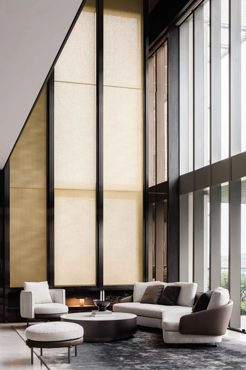 The triple-height screen lends texture to the airy space