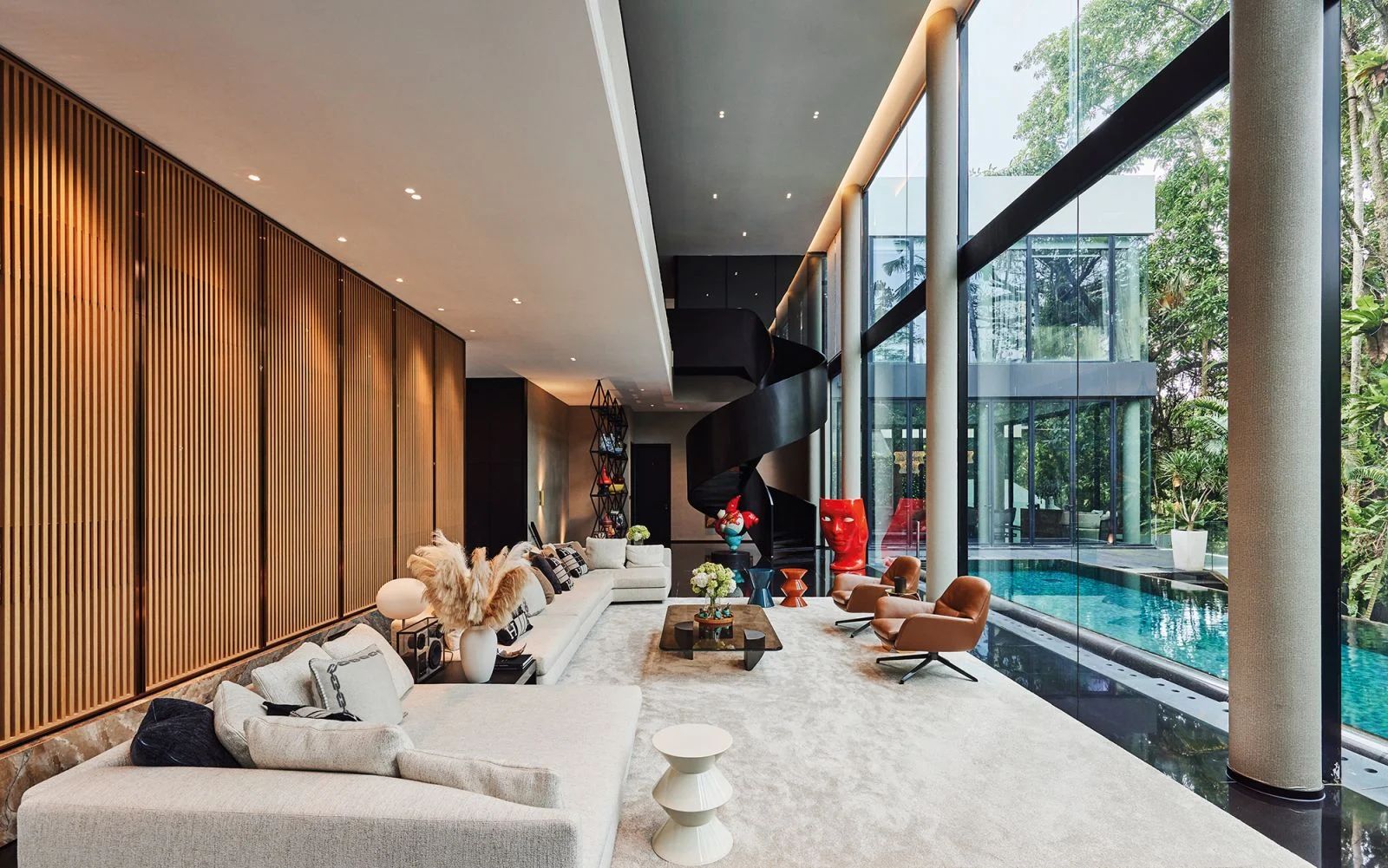 The grand scale of the Good Class Bungalow's ground-floor sitting area allows statement furniture, artworks and sculptural elements to shine against the lush views